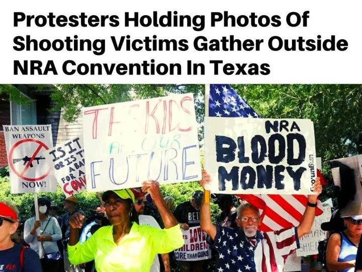 protesters holding photos of shooting victims gather outside nra convention in texas n.
